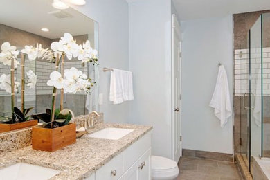 Design ideas for a large traditional master wet room bathroom in Detroit with shaker cabinets, white cabinets, a two-piece toilet, white walls, an undermount sink, granite benchtops, a double vanity, a built-in vanity, beige tile, stone tile, ceramic floors, beige floor and a hinged shower door.