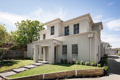 Design ideas for a two-storey brick beige house exterior in Melbourne with a hip roof and a tile roof.