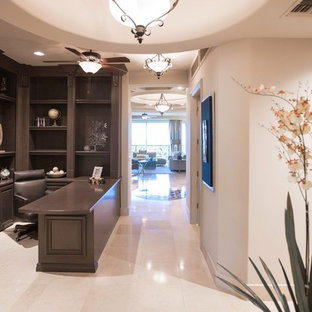 Medium sized modern study in Las Vegas with beige walls, marble flooring, no fireplace and a built-in desk.