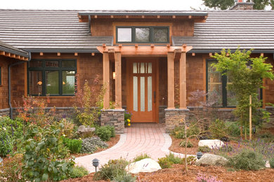 Mid-sized arts and crafts brown one-story wood exterior home photo in Seattle