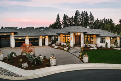 Example of a huge trendy beige one-story mixed siding house exterior design in Portland with a shingle roof and a gray roof