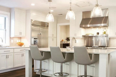 Open concept kitchen - large contemporary u-shaped dark wood floor and brown floor open concept kitchen idea in New York with an undermount sink, shaker cabinets, white cabinets, quartz countertops, beige backsplash, matchstick tile backsplash, stainless steel appliances, an island and white countertops