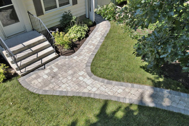 This is an example of a small rustic front yard concrete paver walkway in Other.