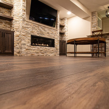 Basement Showing Warm Colors, Straight Lined Cabinets and Stacked Stone