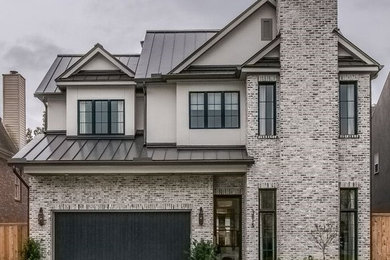 Mid-sized transitional gray three-story brick gable roof photo in Houston