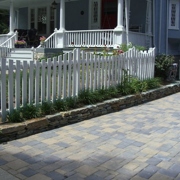 Picket fence and paver driveway