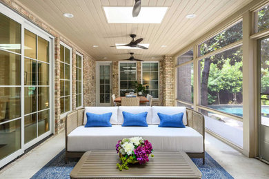 This is an example of a large traditional concrete back porch design in Dallas with a roof extension.