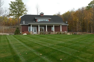 Mid-sized cottage red two-story wood exterior home idea in Other with a gambrel roof
