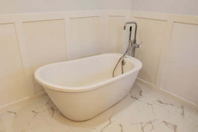 Example of a mid-sized 1960s master blue tile and travertine tile marble floor, gray floor and double-sink bathroom design in Vancouver with flat-panel cabinets, white cabinets, a one-piece toilet, gray walls, a drop-in sink, granite countertops, a hinged shower door, white countertops and a freestanding vanity