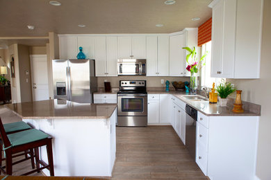 Open concept kitchen - mid-sized craftsman l-shaped open concept kitchen idea in Salt Lake City with an undermount sink, recessed-panel cabinets, white cabinets, granite countertops, stainless steel appliances and an island