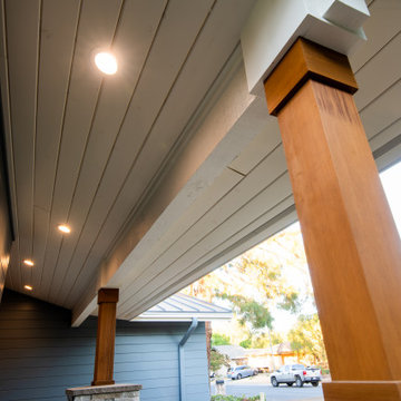 Contemporary Front Awning with Sleek Wood Columns and Recessed Lighting