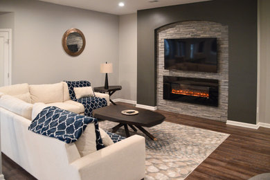 Example of a mid-sized open concept brown floor living room design in Detroit with a hanging fireplace, a concrete fireplace and a wall-mounted tv