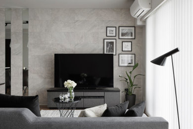 Modelo de salón gris y gris y negro con paredes grises, suelo de contrachapado, televisor independiente, suelo marrón, papel pintado y papel pintado