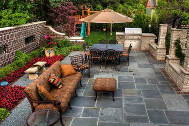 Design ideas for a large transitional backyard patio in Los Angeles with an outdoor kitchen and tile.