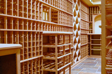 Example of a small arts and crafts multicolored floor wine cellar design in New York with storage racks