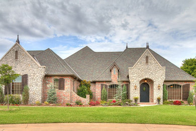 Inspiration for a timeless two-story brick house exterior remodel in Oklahoma City