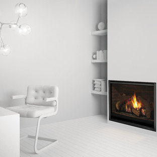 This is an example of a medium sized modern study in Cincinnati with white walls, light hardwood flooring, a standard fireplace, a plastered fireplace surround, a freestanding desk and white floors.