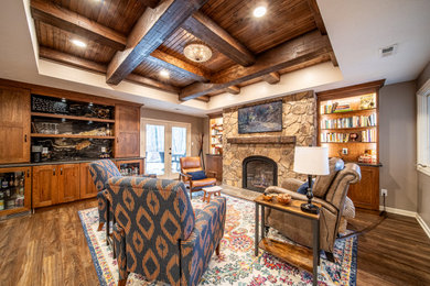 Design ideas for a large country walk-out basement in Other with brown walls, vinyl floors, a standard fireplace, a stone fireplace surround, brown floor and exposed beam.