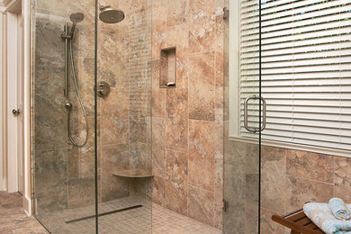 Design ideas for a mid-sized transitional master bathroom in Atlanta with a curbless shower, brown tile, porcelain tile, porcelain floors, brown floor and a hinged shower door.