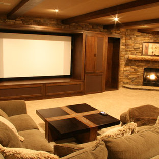 Large mountain style enclosed carpeted and brown floor home theater photo in Cincinnati with brown walls and a projector screen