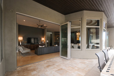 Inspiration for a large contemporary open concept travertine floor and beige floor living room remodel in Phoenix with gray walls, no fireplace and a tv stand