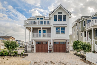 Inspiration for a coastal gray three-story house exterior remodel in Philadelphia