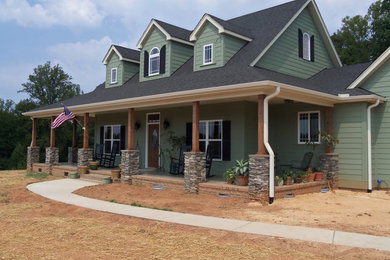 Large arts and crafts green two-story concrete fiberboard exterior home photo in Charleston with a tile roof