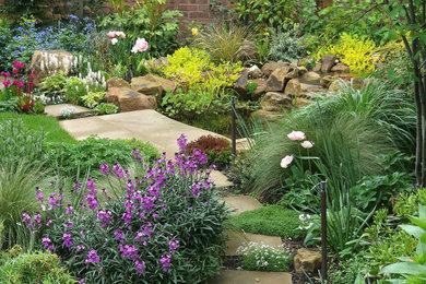 Inspiration for a small back full sun garden for summer in London with a pond, natural stone paving and a wood fence.