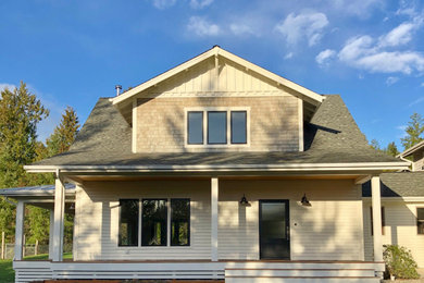 Mid-sized country front porch idea in Seattle with a roof extension