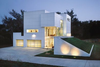 Inspiration for a large modern attached three-car garage remodel in Kansas City