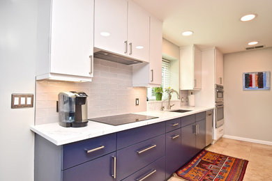 Example of a mid-sized minimalist u-shaped porcelain tile and beige floor eat-in kitchen design in Tampa with an undermount sink, shaker cabinets, blue cabinets, quartz countertops, beige backsplash, subway tile backsplash, stainless steel appliances, two islands and white countertops