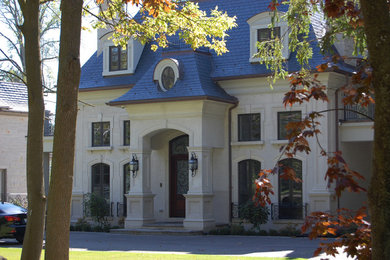 Traditional beige two-story stone exterior home idea in Toronto
