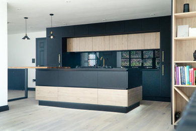Black Contemporary Kitchen with Brass Detailing