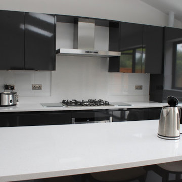 Sleek Modern Black Kitchen with Island by Kudos Interior Design