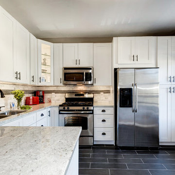 White Kitchen Remodel with Colonial White Granite and Stainless Steel Appliances