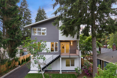 Inspiration for a mid-sized contemporary gray three-story concrete fiberboard and clapboard exterior home remodel in Seattle with a shingle roof and a gray roof