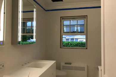 Freestanding bathtub - small modern master white tile and porcelain tile double-sink freestanding bathtub idea in Miami with flat-panel cabinets, white cabinets, a one-piece toilet, solid surface countertops, white countertops and a freestanding vanity