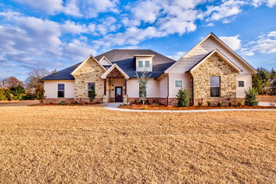 Large cottage beige mixed siding exterior home photo in Oklahoma City with a shingle roof