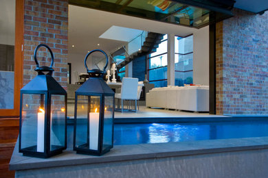 Small modern rectangular natural pool in Melbourne with natural stone pavers.