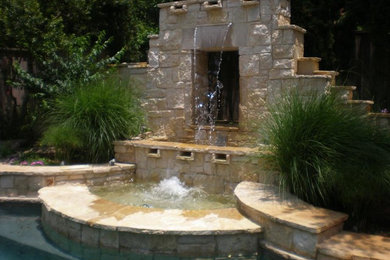Inspiration for a contemporary patio in Dallas with a water feature and natural stone pavers.