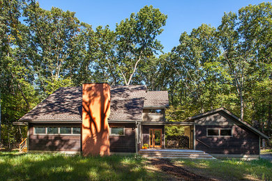 Inspiration for a mid-sized modern brown two-story mixed siding gable roof remodel in Detroit