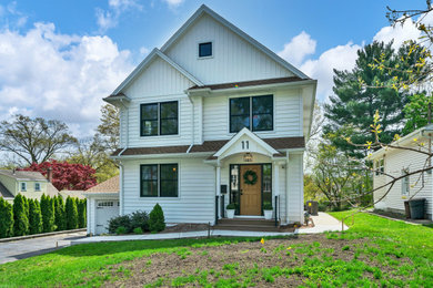 White house exterior photo in New York with a shingle roof and a brown roof