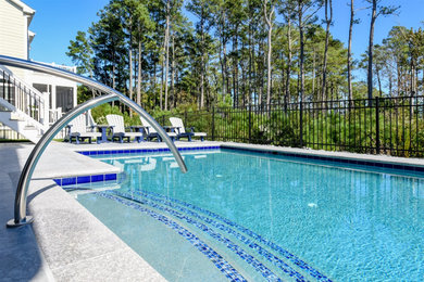 Pool - mid-sized coastal backyard tile and custom-shaped pool idea in Other