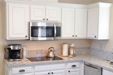 Example of a mid-sized transitional u-shaped eat-in kitchen design in Other with white cabinets, stainless steel appliances and an island