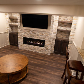 Basement Showing Warm Colors, Straight Lined Cabinets and Stacked Stone