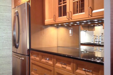 Inspiration for a transitional galley medium tone wood floor and brown floor eat-in kitchen remodel in New York with an undermount sink, shaker cabinets, gray backsplash, subway tile backsplash, stainless steel appliances, light wood cabinets, quartz countertops and no island