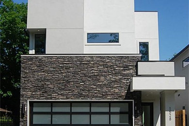 Example of a large trendy gray two-story exterior home design in Houston
