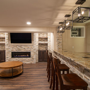 Basement Showing Warm Colors, Straight Lined Cabinets and Stacked Stone