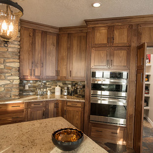 Huge traditional kitchen pantry appliance - Kitchen pantry - huge traditional l-shaped ceramic floor kitchen pantry idea in Calgary with an undermount sink, flat-panel cabinets, dark wood cabinets, quartz countertops, brown backsplash, glass tile backsplash, stainless steel appliances and an island