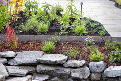 Design ideas for a mid-sized traditional drought-tolerant and full sun backyard stone waterfall in Portland.